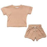 Toddler beige waffle outfit with a short-sleeve top and shorts on a white background