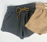 Gray charcoal toddler waffle shorts with brown drawstring and tan waffle toddler shorts with beige drawstring against white background.
