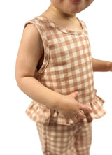A child wearing a beige and brown gingham tank top and matching pants set.