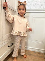 a girl standing in front of a door