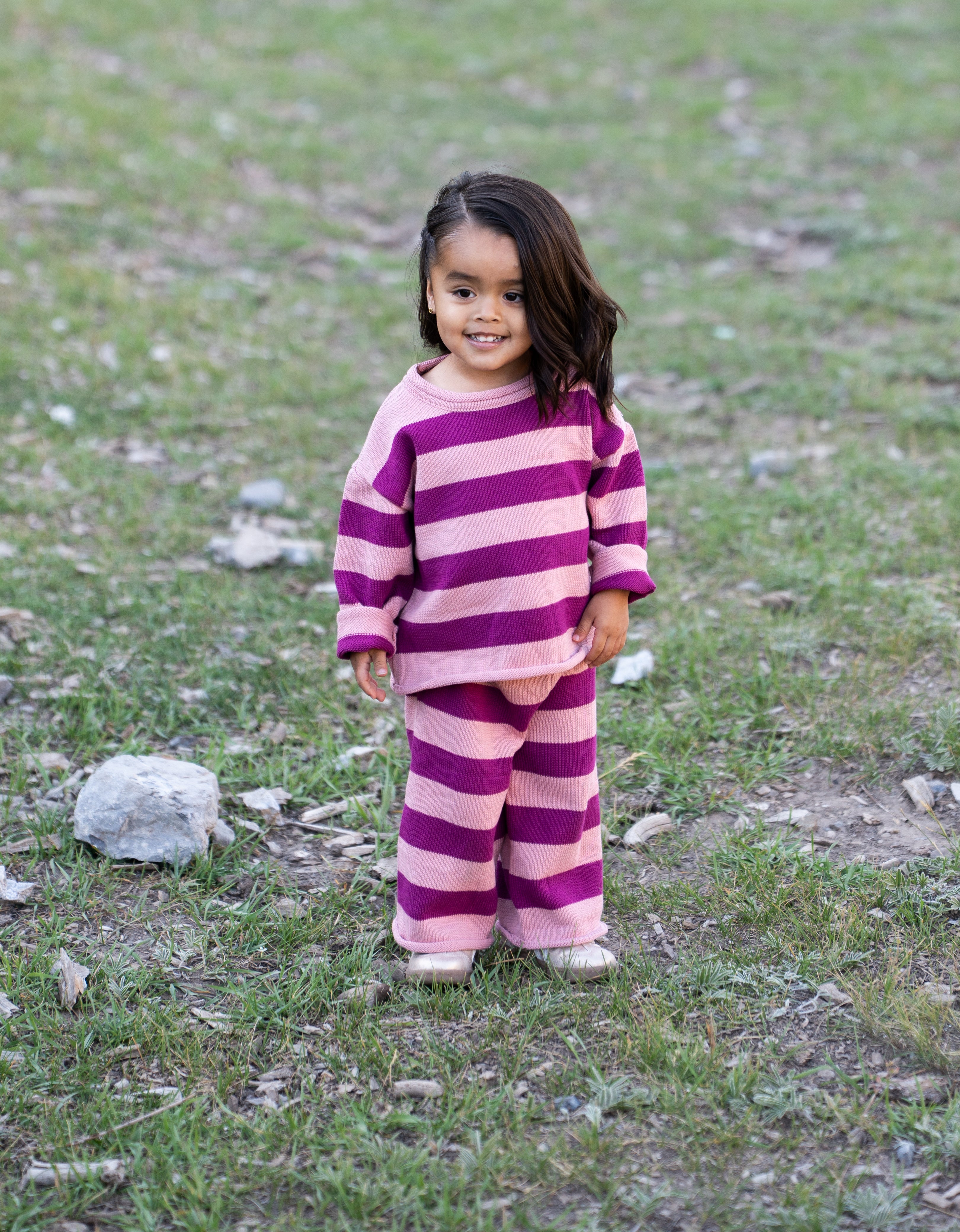 a child standing in a grassy area
