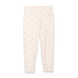 A pair of ribbed knit leggings in a warm off-white/cream color, featuring an allover pattern of small peach-pink polka dots, shown flat against a white background.