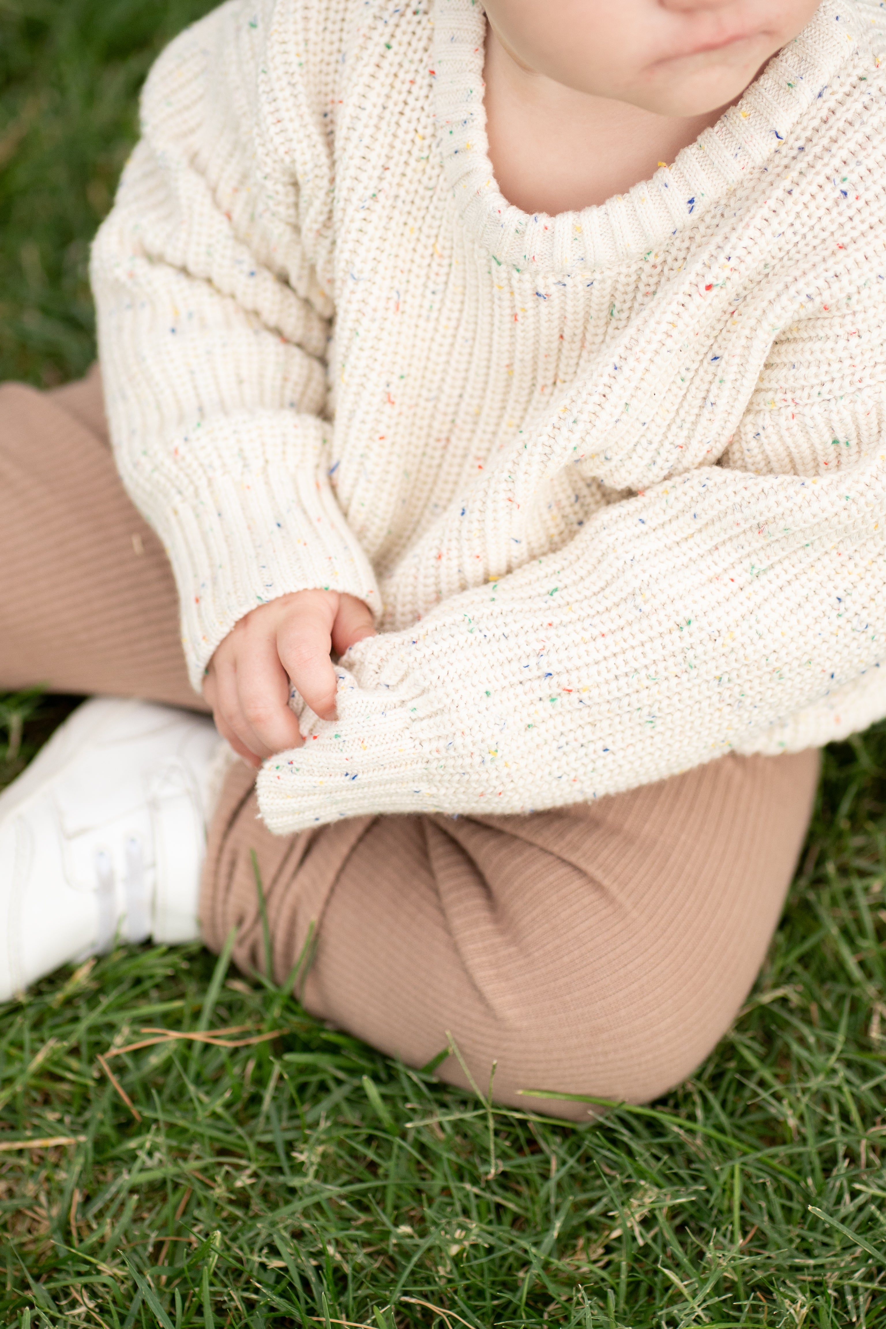a child sitting on the grass