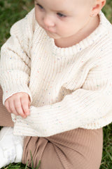 a child sitting on grass