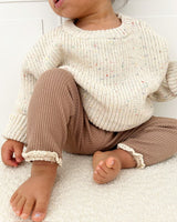 a baby sitting on a carpet