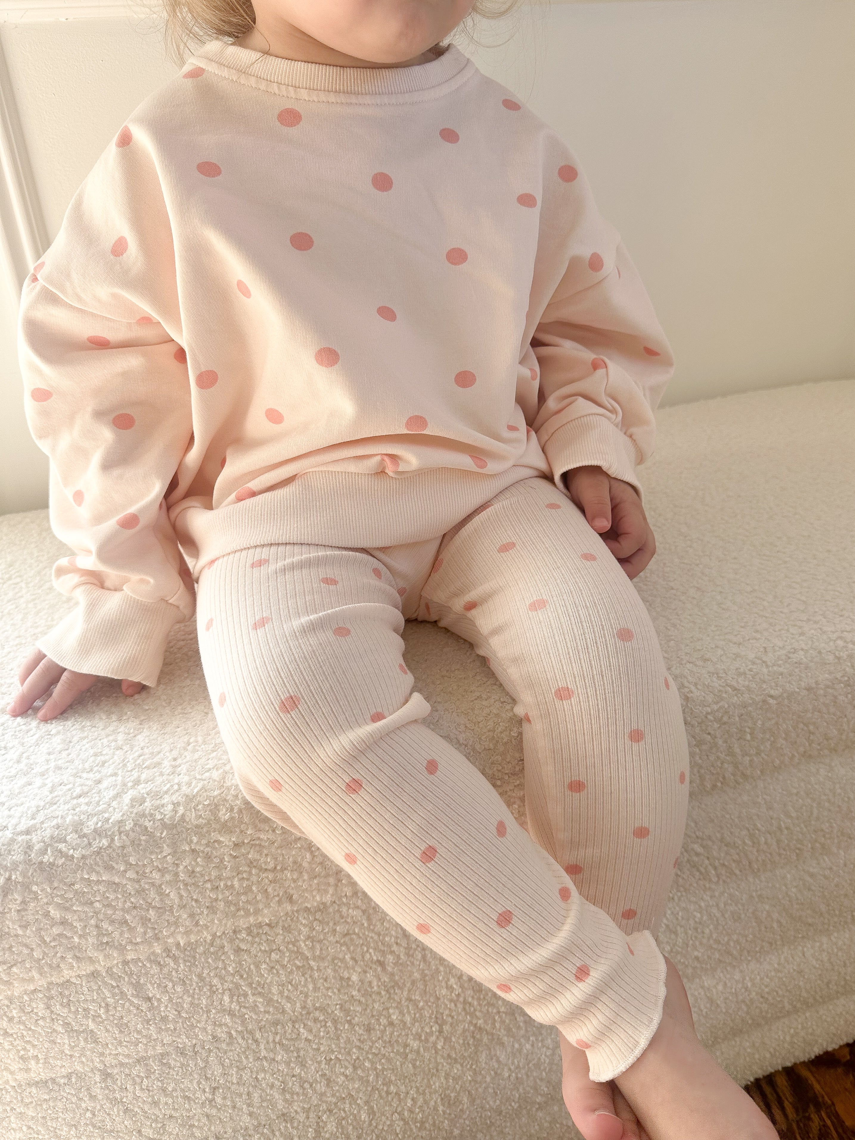 a child sitting on a bed