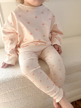 a child sitting on a bed