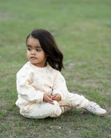 a child sitting on the grass